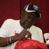 Emile Griffith adds his signature to a fans boxing glove