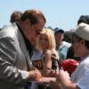 Hall of Fame promoter Bob Arum autographs a program for a fan