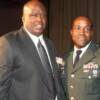 James "Buster" Douglas poses with a an active duty soldier from Fort Drum