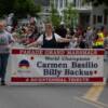 Young fans carry a sign letting fans know the grand marhsals - Carmen Basilio and Billy Backus - are up next in the Parade of Champions 