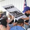 Jeff Fenech signs a ROCKY poster at the Opening Ceremony.