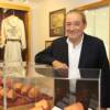 Hall of Fame promoter Bob Arum poses by the fist casting exhibit in the Museum.