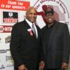 Heavyweight champions Michael Moorer and Leon Spinks pose by HOF sponsor logos