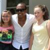 Sugar Ray Leonard takes a photo with two fans