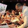 Tommy "Hitman" Hearns signs autographs for his many fans
