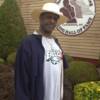 Hall of Fame light heavyweight and heavyweight champion Michael Spinks poses by the Hall of Fame logo