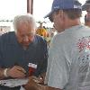 Hall of Fame promoter Don Chargin signs autographs for fans.