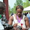 2012 Olympic gold medalist Claressa Shields signs autographs for fans.