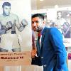 Amir "King" Khan poses by Muhammad Ali exhibit in Hall. 