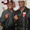 Leon and Michael Spinks pose for a photo by Hall of Fame logo.