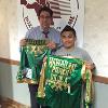 Brian Viloria donates fight worn robe and trunks to Hall director Ed Brophy.
