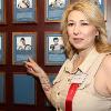 Teresa Tapia poses by Johnny's Hall of Fame plaque.