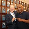Jim Gray and Mike Tyson pose by Gray's Hall of Fame plaque