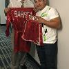 Marco Antonio Barrera presents Hall director Ed Brophy with the robe and trunks from his second bout with Manny Pacquiao.