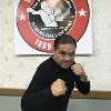 Hall of Fame light flyweight champion Humberto "Chiquita" Gonzalez in fighting pose by the 30th logo