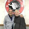 DeMarco and his wife Dottie take photo by the Hall of Fame logo