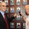 Russell Peltz (left) and Don Chargin (right) point to Lorraine Chargin's plaque on the HOF Wall