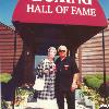 Hall of Famers Don and Lorraine Chargin pose by the HOF Museum entrance 