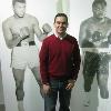 Osuna takes a photo in between life-size photos of Ali and Frazier