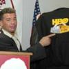 Gatti points to an HBO World Championship Boxing jacket that was part of the live auction