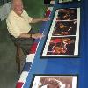 Lederman sits on stool next to famous MSG ring on permanent display in Hall 