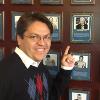 HBO's Spanish interpreter Jerry Olaya poses by Larry Merchant's Hall of Fame plaque