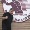 George Chuvalo poses by the Hall of Fame logo