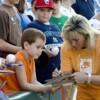 A young fan gets an autograph from "The Coal Miner's Daughter."