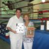 Hall director Ed Brophy and NYSAC chairperson Melvina Lathan pose by the MSG ring with press kits and programs from fights that took place in the Garden.