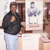 Spinks raises a fist next to the Muhammad Ali exhibit. 