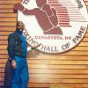 Spinks poses by the Hall of Fame logo. 