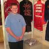 Bert Sugar's grandson, Will Randolph Frawley, stands by his grandfather's famous colorful pants on display in the Hall.