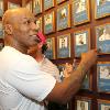 Tyson points to Cus D'Amato's plaque on the Hall of Fame Wall