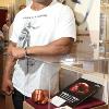 Posing by his exhibit that includes his fist impression and program and ticket from his first world title bout against Trevor Berbick