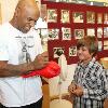 "Iron" Mike happily signs an autograph for a young fan