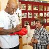 "Iron" Mike happily signs an autograph for a young fan