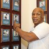A 2011 Hall of Fame Inductee, Tyson proudly points to his plaque on the Hall of Fame Wall